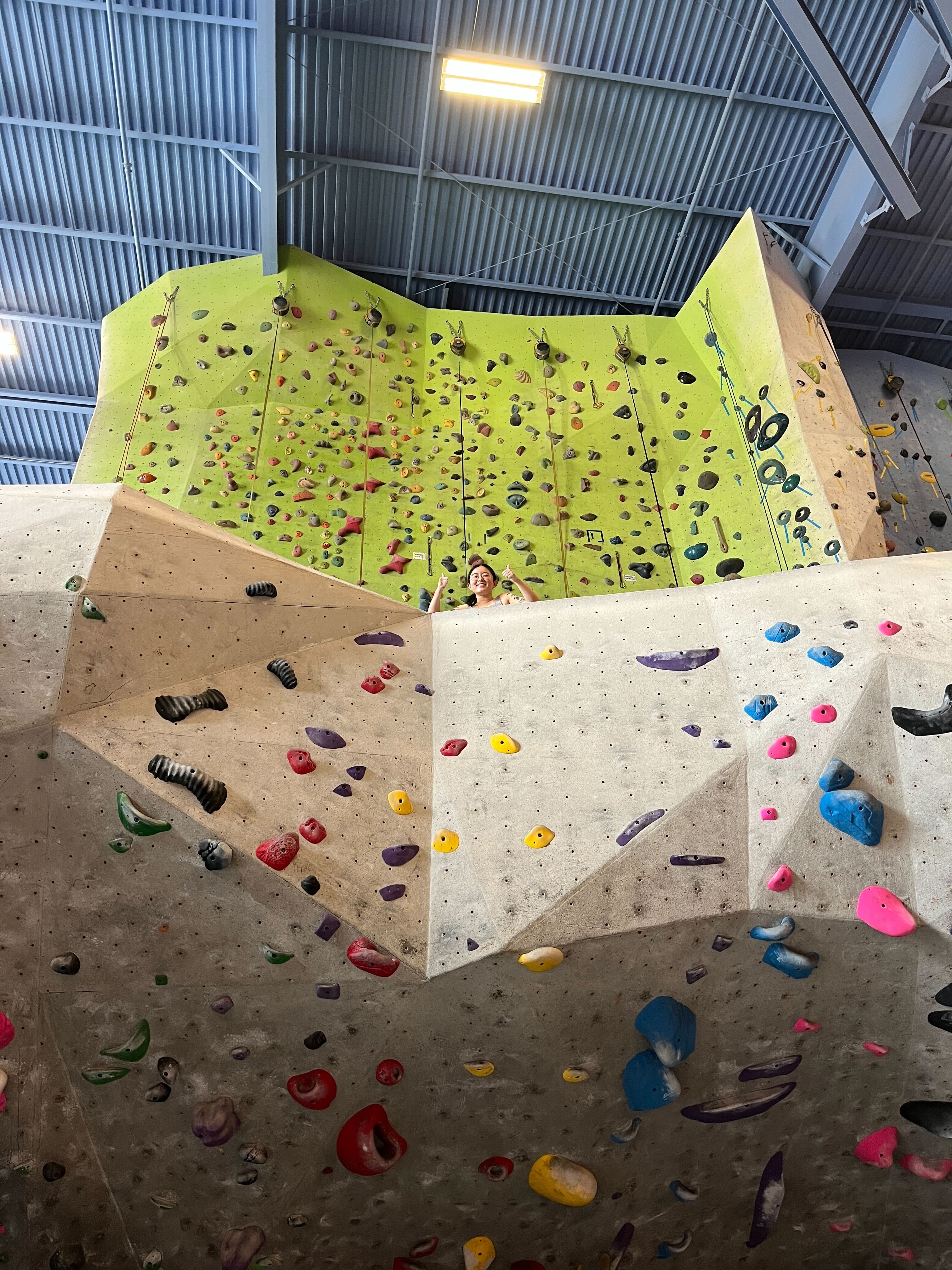 photo of Xinyun in front of a rock climbing wall